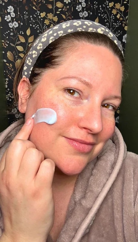 Catrina demonstrating a skincare product